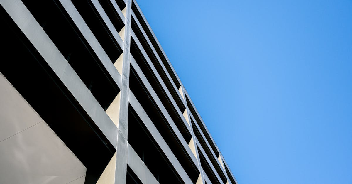 Contemporary building with geometric design against a clear blue sky, showcasing modern architecture.