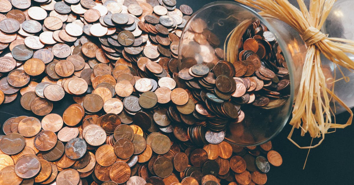 Spilled jar of pennies creating a pattern of coins representing savings and finance.
