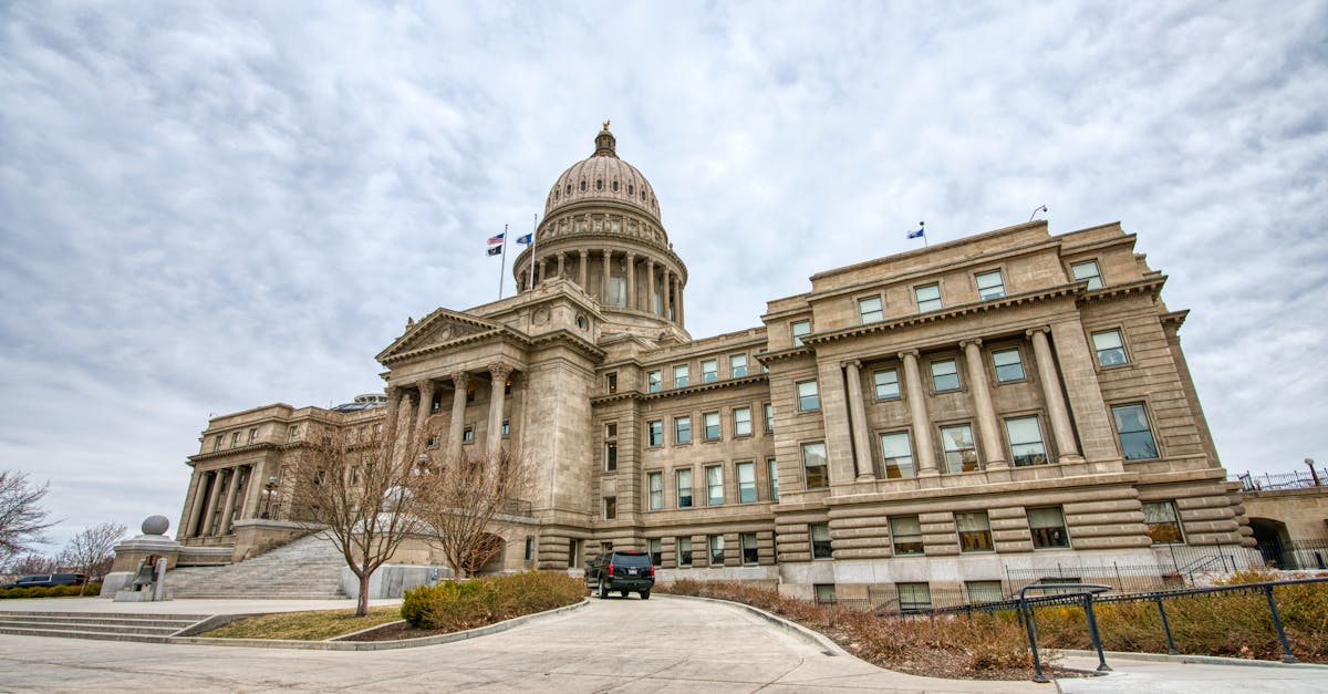 Majestic view of the Idaho State Capitol with its iconic dome under a cloudy sky.