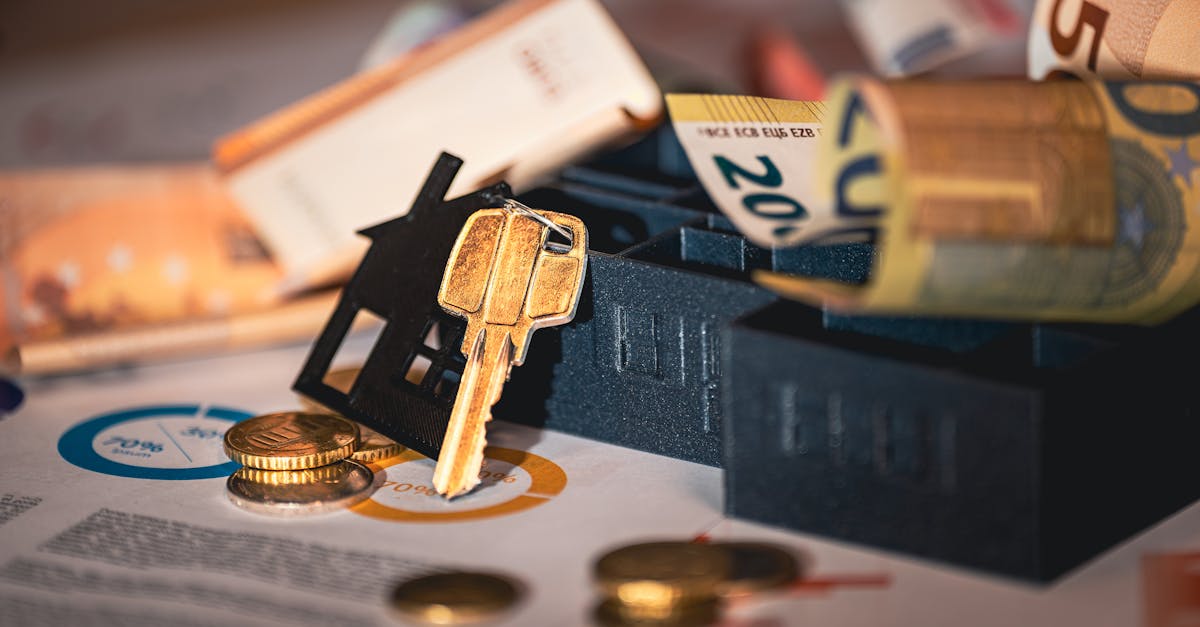Close-up of house keys, euro bills, and charts symbolizing real estate investment and finance.