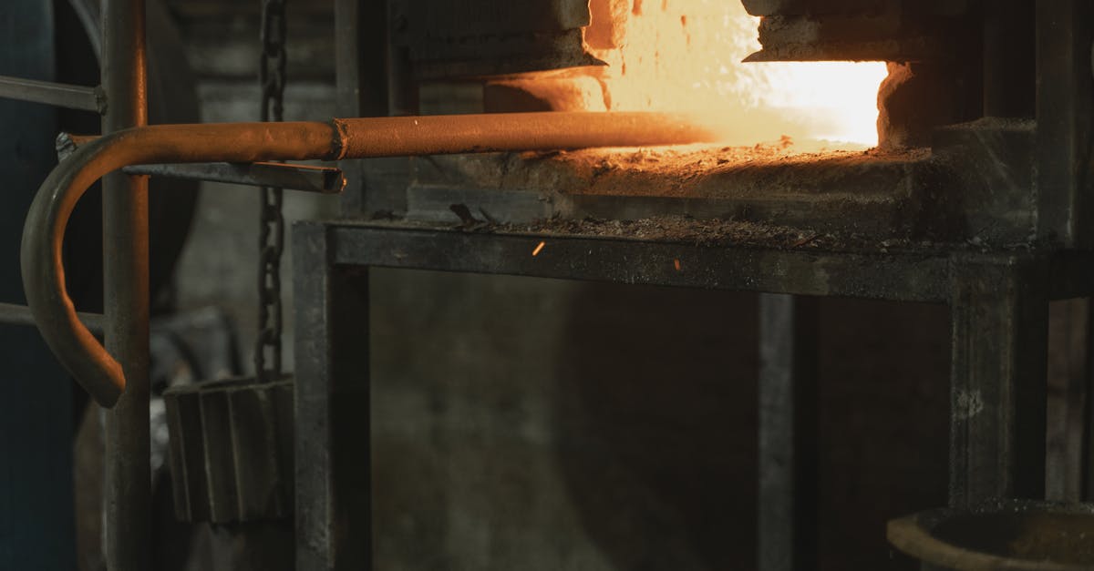Close-up of metal being heated in a blacksmith forge, showcasing industrial craftsmanship.