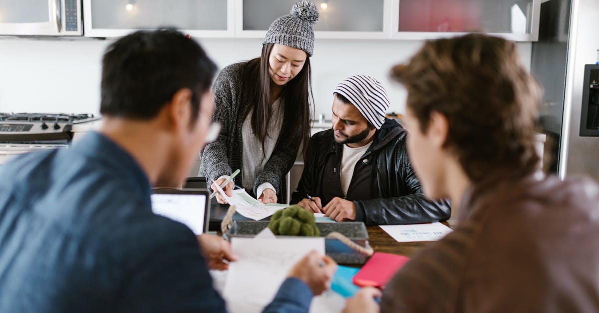 A dynamic group of young entrepreneurs brainstorming in a well-lit office space.