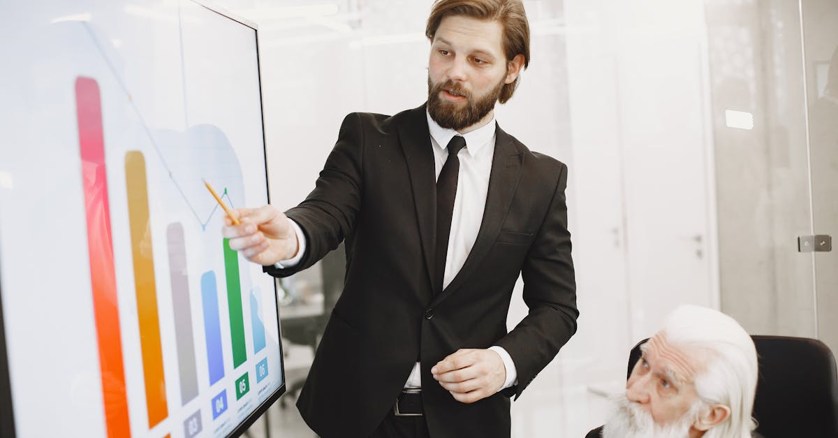 Two businessmen discussing data trends during a presentation in a modern office setting.