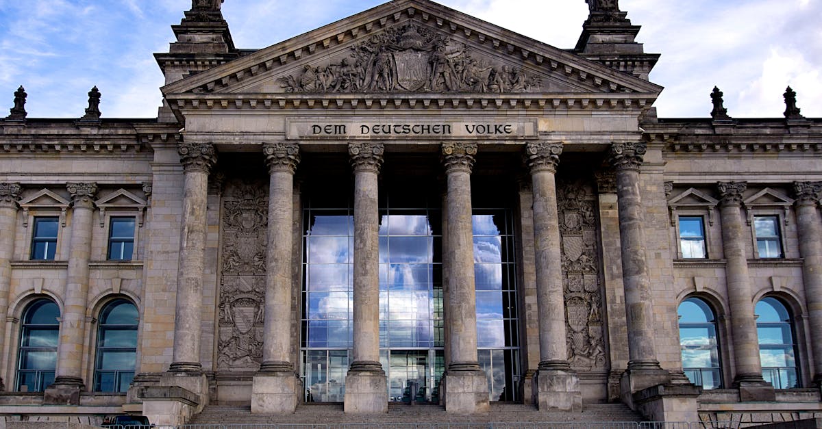 Historic Reichstag building facade with columns and steps in Berlin, Germany.