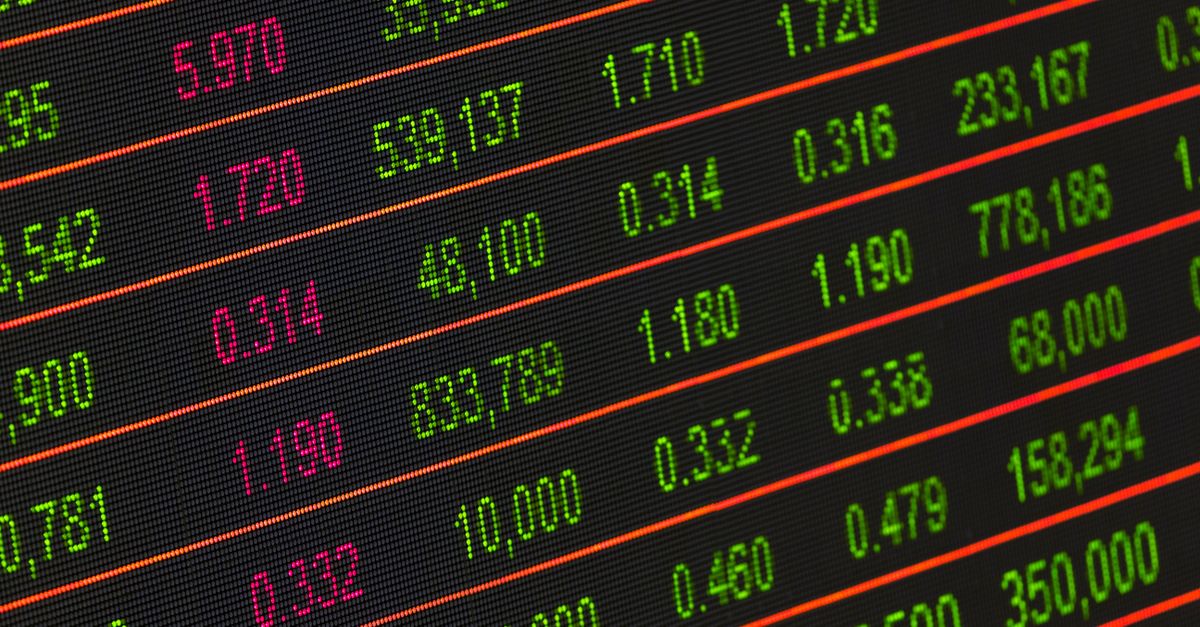 Close-up of a digital stock market data display showing colorful financial numbers and trends.