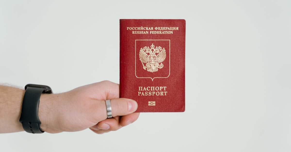 Close-up of a hand holding a Russian Federation passport.