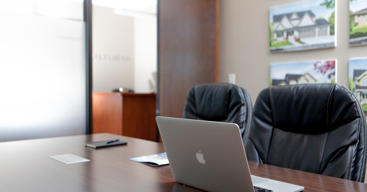 Sleek modern office interior featuring a laptop and art decor for a professional workspace.