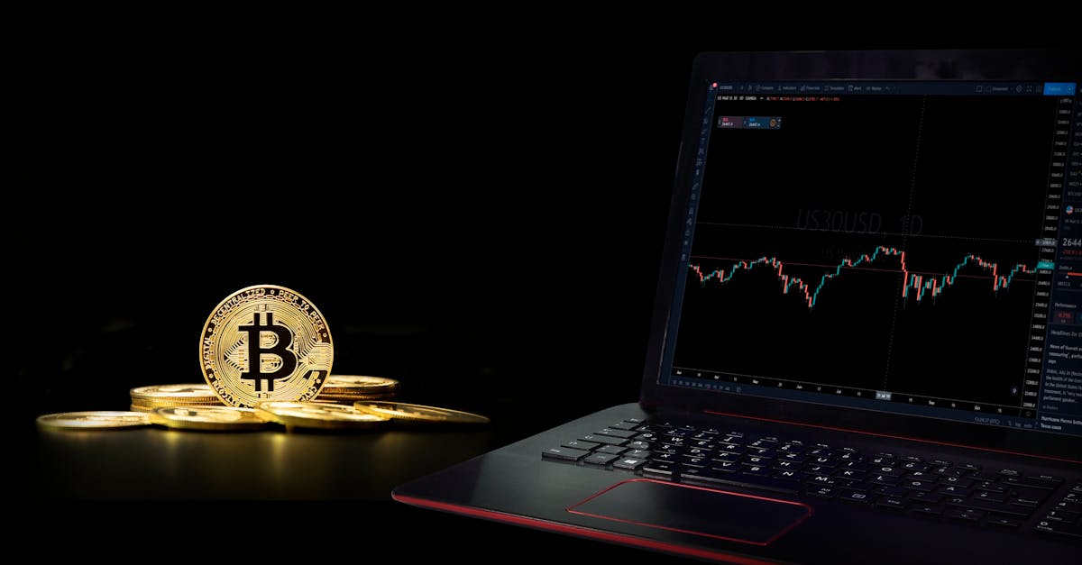Golden bitcoin coins next to a laptop displaying a trading graph, symbolizing digital currency investment.