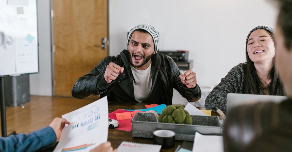 Energetic office meeting showcasing teamwork and innovative idea sharing among young entrepreneurs.