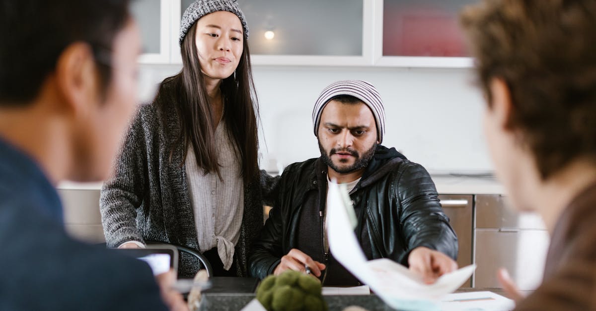 Group of young entrepreneurs brainstorming and collaborating in a modern office setting.
