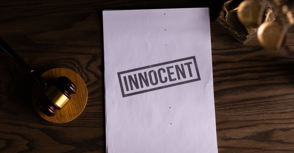 Close-up of legal document stamped 'Innocent' beside a gavel on a wooden desk.