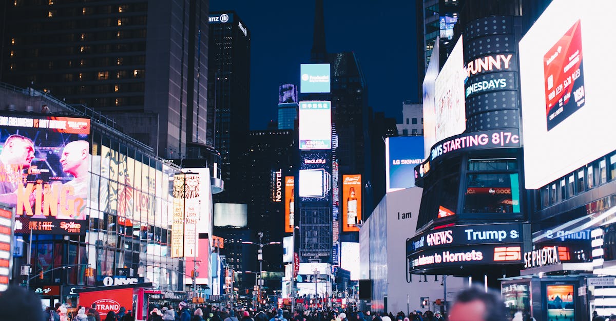 Bustling night scene in Times Square, New York City, illuminated with vibrant advertisements.