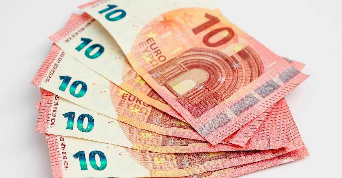 Close-up of a fan of 10 euro banknotes on a clean white background, showcasing European currency.