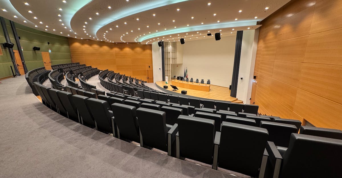 A panoramic view of a modern auditorium with seating arrangements and stage in Milan.