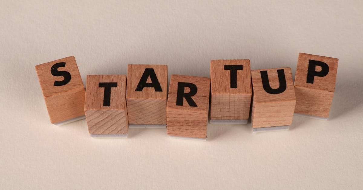 Wooden blocks forming the word 'STARTUP' on a neutral background, symbolizing new business ventures.