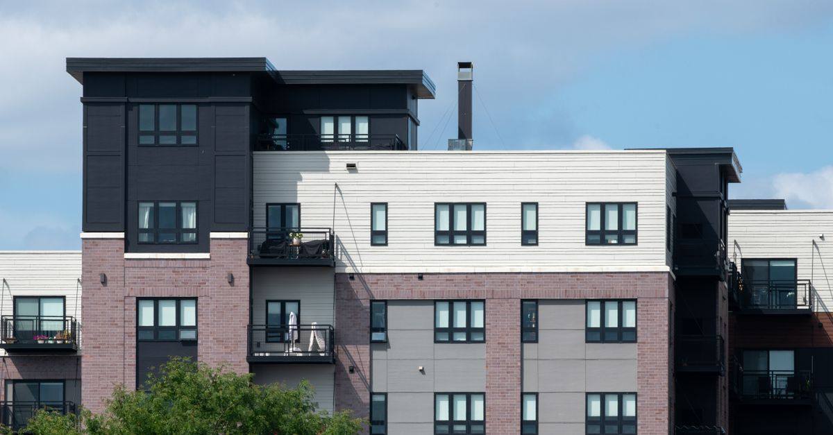Contemporary apartment complex showcasing diverse architectural styles and multiple balconies.