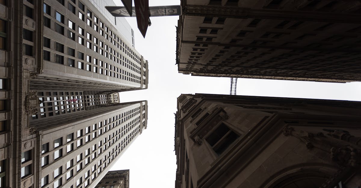 Dramatic upward view of tall skyscrapers in an urban setting, showcasing architectural design.