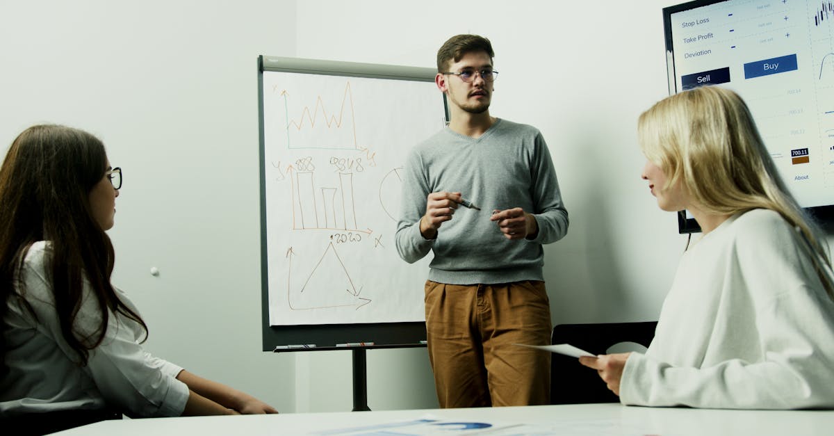 Adults discussing financial charts during a teamwork session.