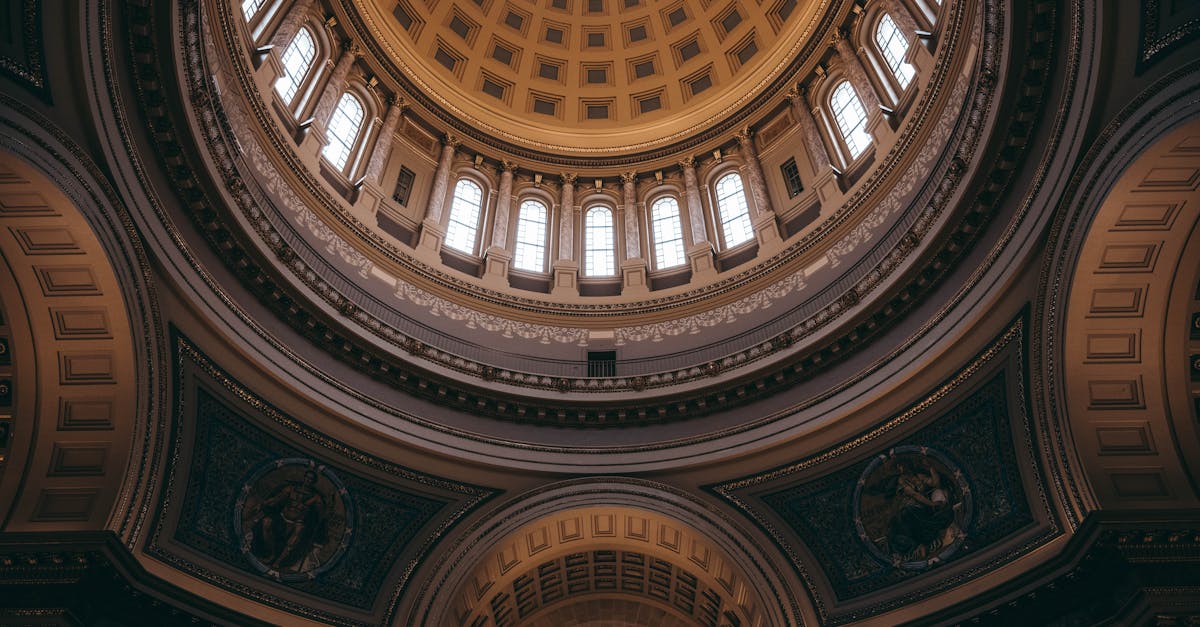 Intricate architectural dome inside the Wisconsin State Capitol, Madison, showcasing elegant baroque details.