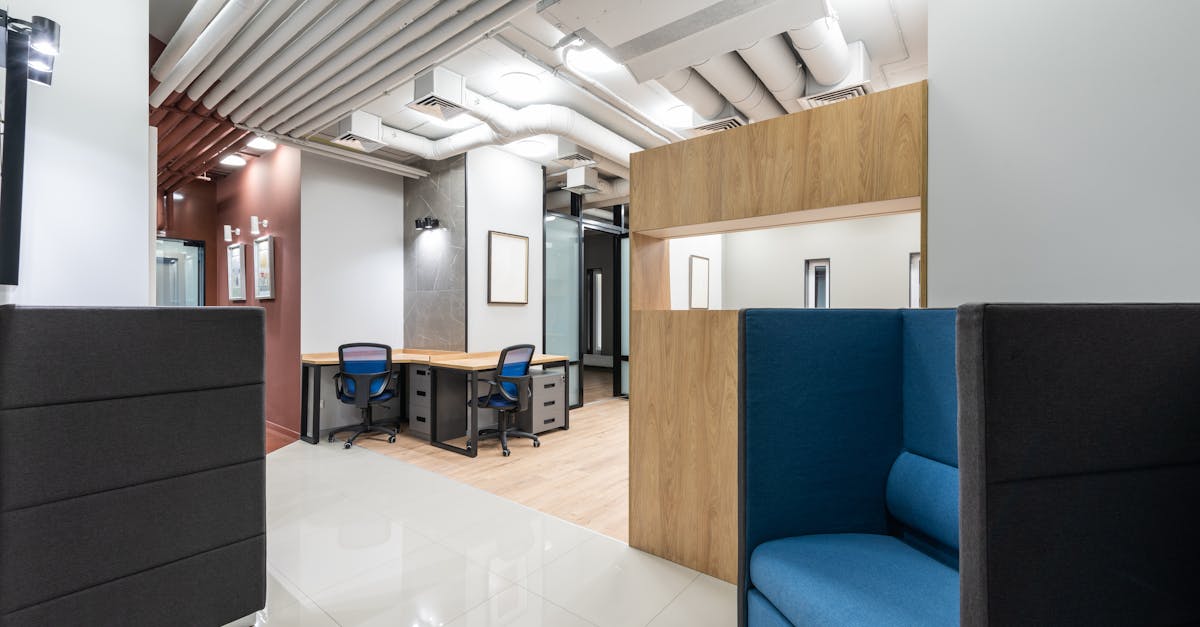 Interior of new spacious office equipped with contemporary furniture including tables and chairs and armchairs