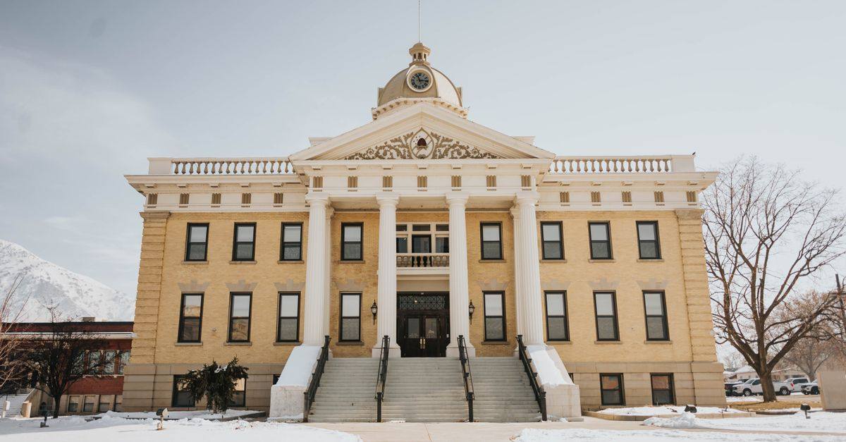 A prominent historic building in Brigham City, Utah, covered in snow during winter.