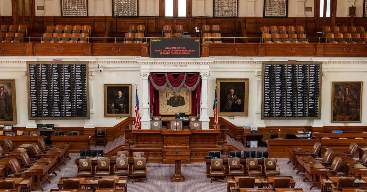 The Texas House of Representatives chamber, featuring legislative seats and historical portraits.