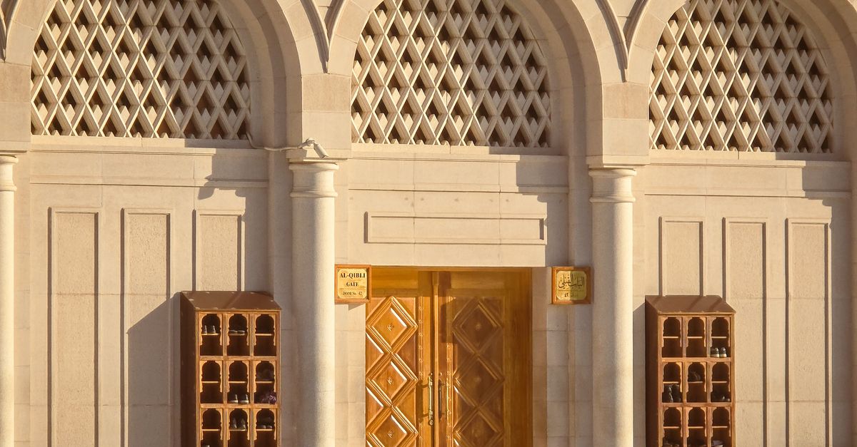 Intricate stone entrance with arched designs and wooden door, perfect for architectural themes.