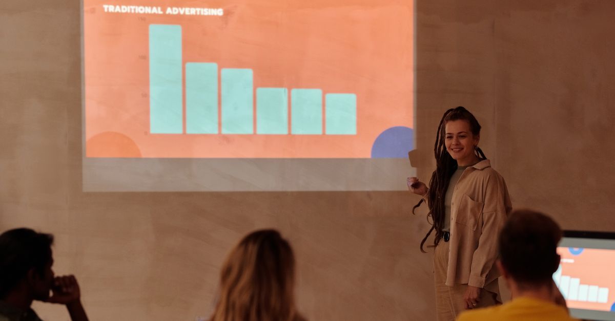 Young professional presenting data with graph in a business meeting.