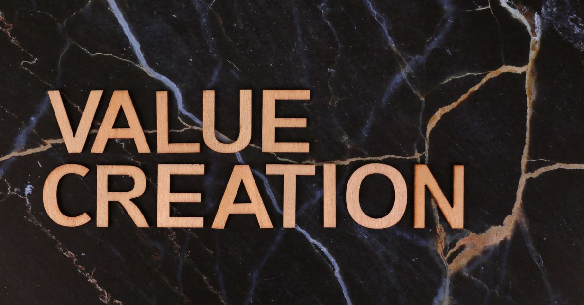 Wooden letters spelling 'Value Creation' on dark marble background, perfect for business themes.