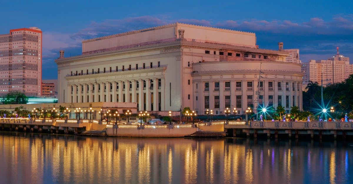 The iconic Manila Central Post Office building reflected in the Pasig River at twilight in Metro Manila, Philippines.