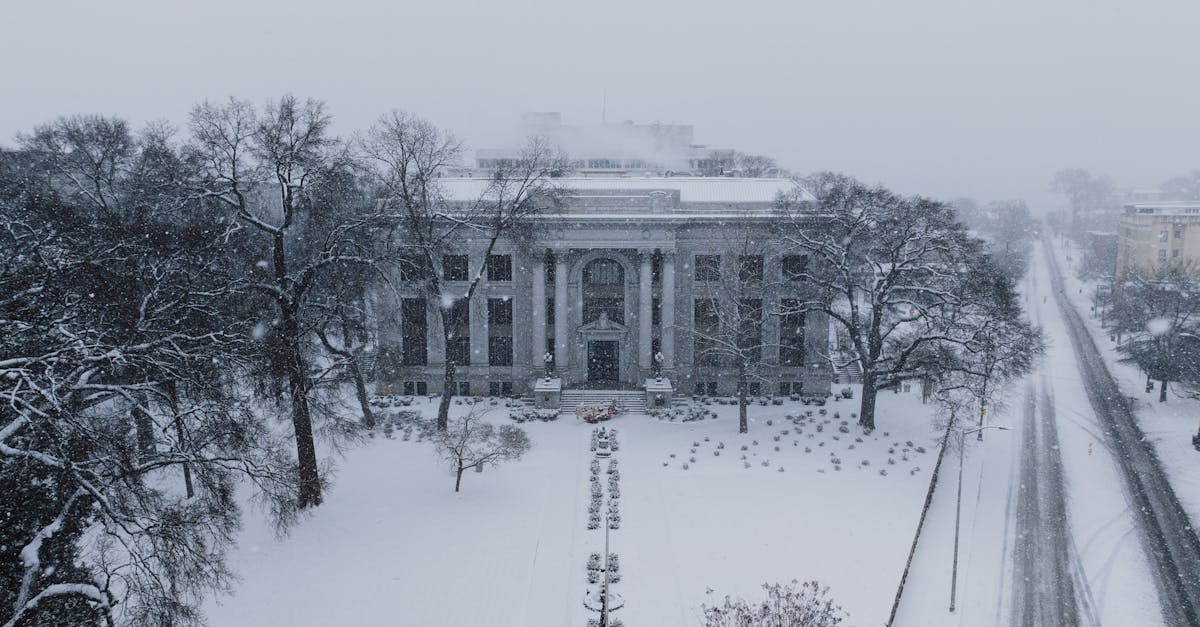 Historic courthouse blanketed in snow, captured on a serene winter day.