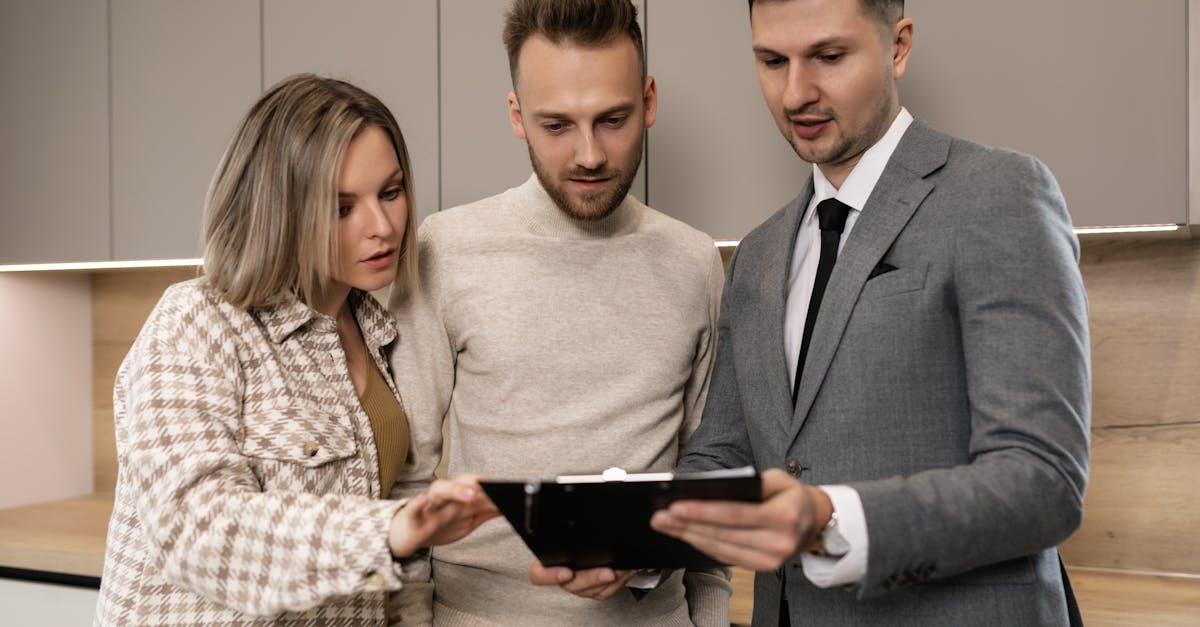 Real estate agent discussing property details with clients indoors.