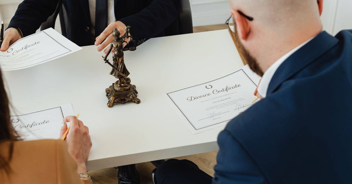 A professional setting with a focus on signing divorce documents in an office environment.