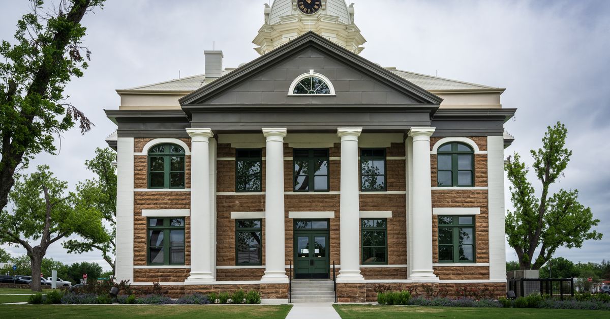 Classic architectural design of Mason County Courthouse, Texas amid lush greenery.