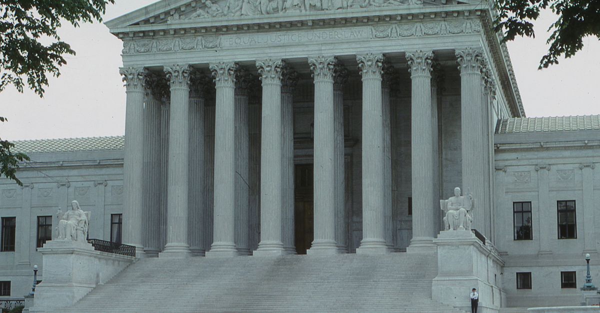 Front view of the iconic Supreme Court building with classical columns and majestic architecture.