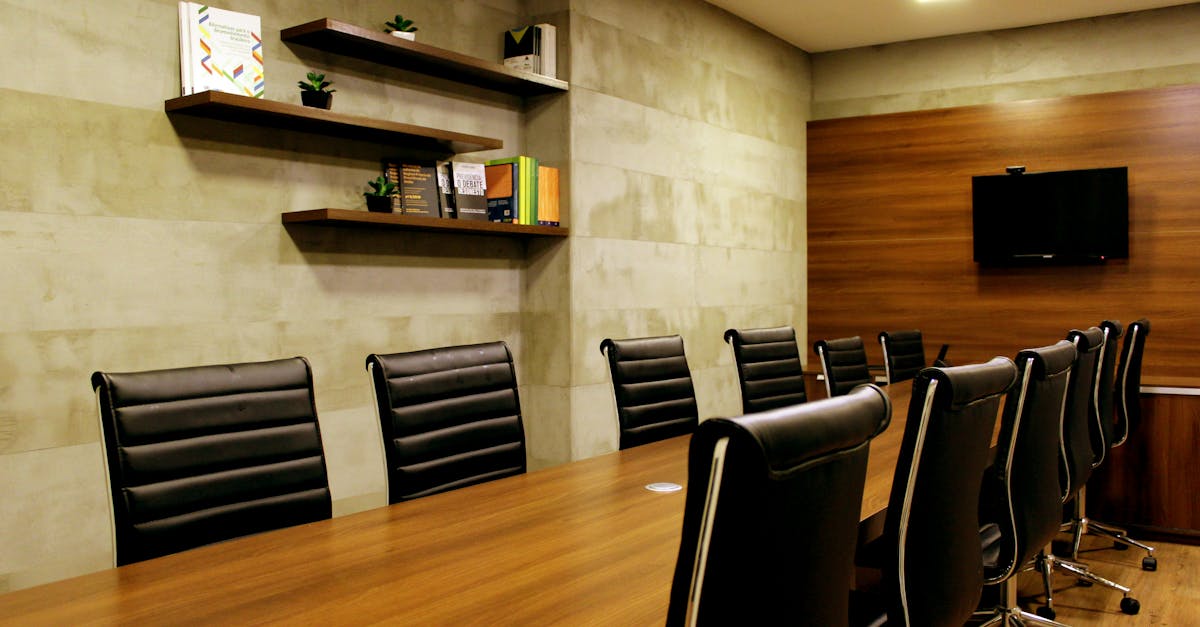 Elegant boardroom with leather chairs and wooden decor, ideal for meetings.