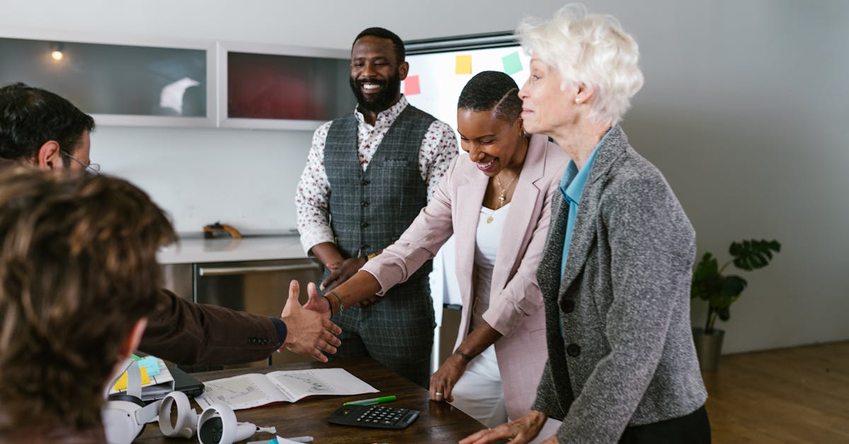 A group of diverse professionals engaged in a collaborative business meeting indoors.