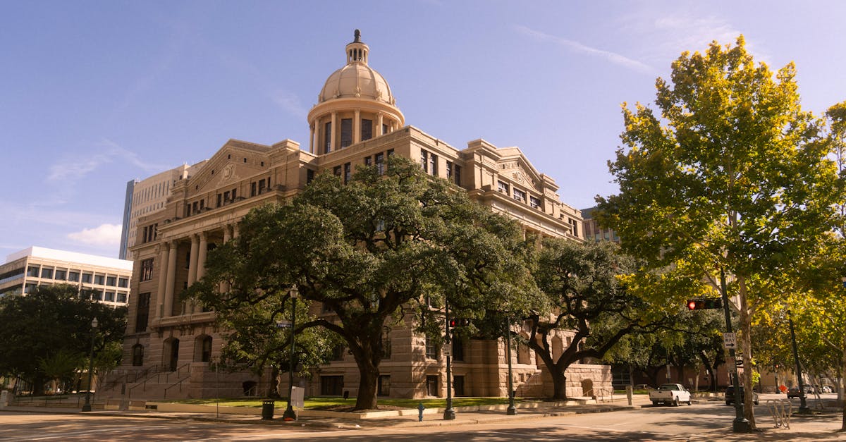 Stunning view of a historic courthouse building with trees, in downtown Houston, Texas.
