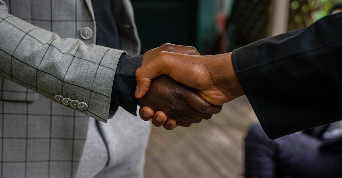 Close-up of two professionals shaking hands, symbolizing success and partnership.