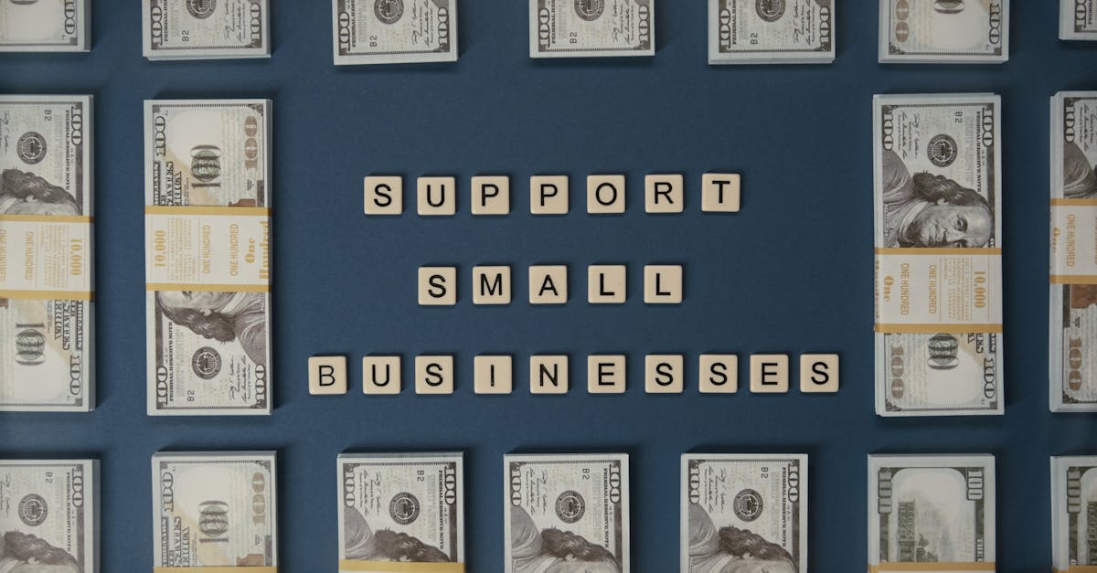 Top view of dollar bills and letter tiles promoting small businesses.