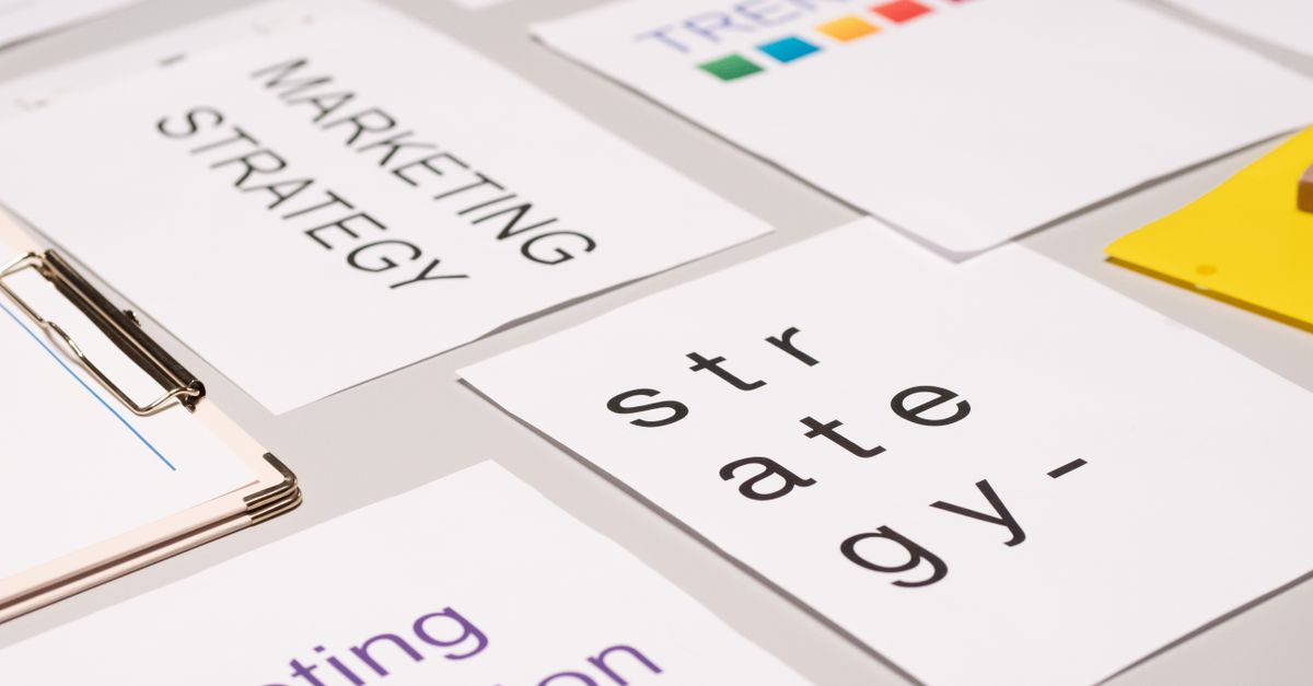 A top view of marketing strategy documents and graphs arranged on a desk, showcasing business planning.