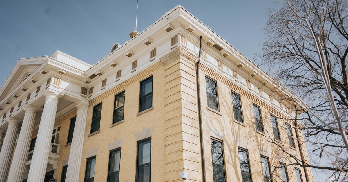Low angle view of the historic Box Elder County Courthouse with columns and blue sky, Brigham City, Utah.