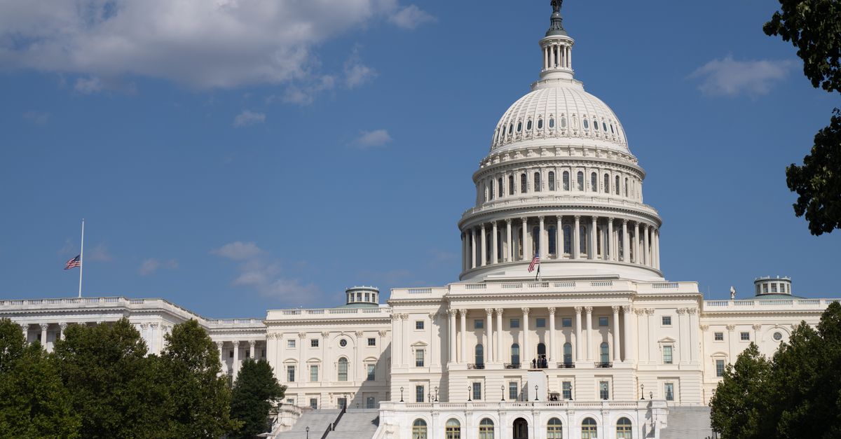 The United States Capitol under clear blue skies, showcasing its iconic architecture.