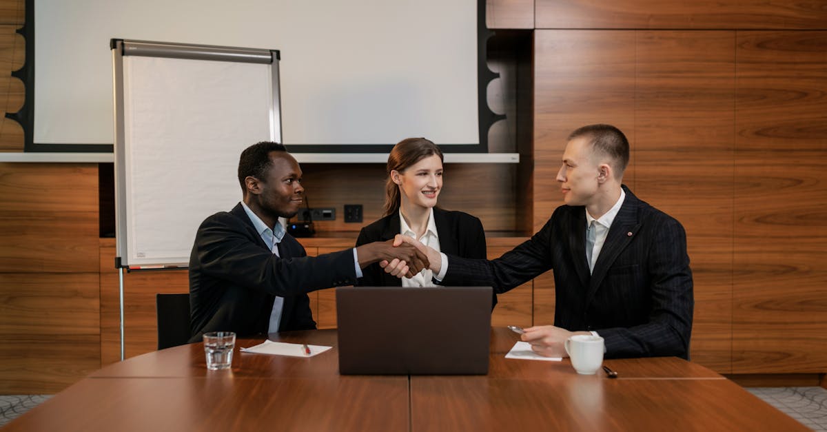 Diverse business team having a successful meeting and agreement, shaking hands across the table.