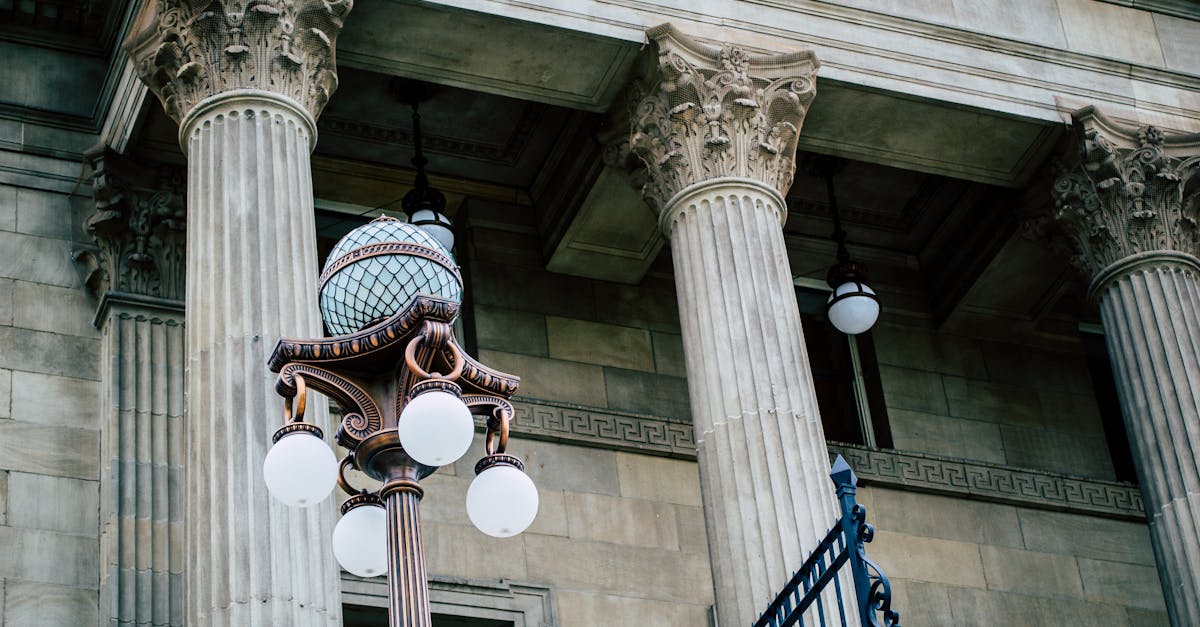 An elegant view of classic architectural columns with an antique street lamp, ideal for urban landscapes.