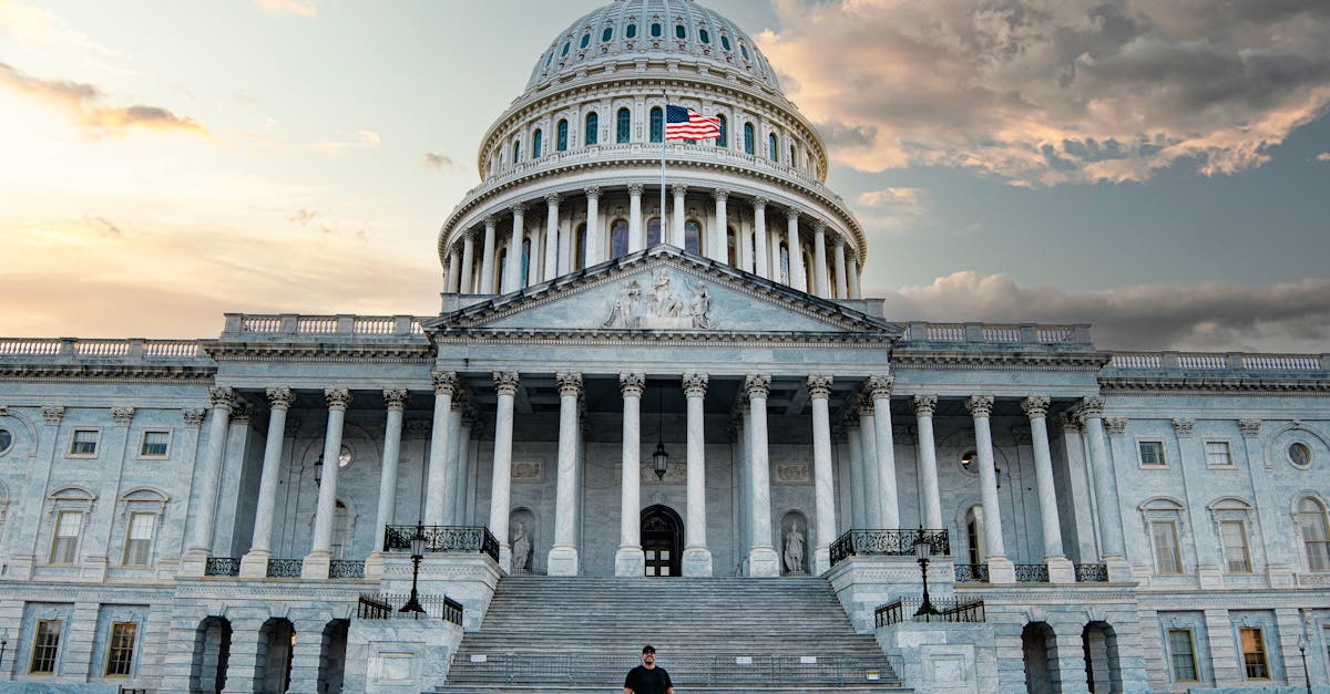 Front view of the iconic United States Capitol with dramatic evening sky.