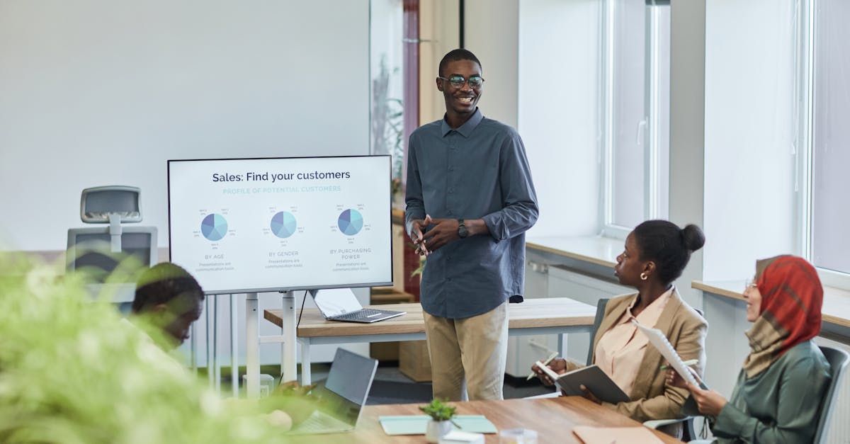 A diverse team having a corporate meeting with a sales presentation in a modern office setting.