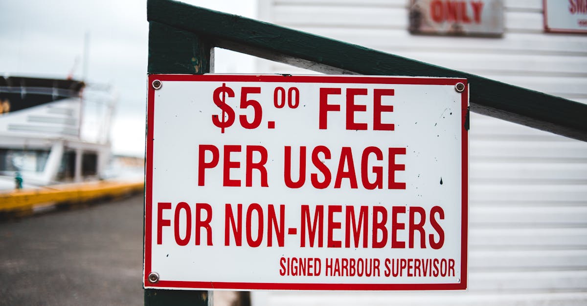 Close-up of a sign indicating a $5 usage fee for non-members at a harbor.