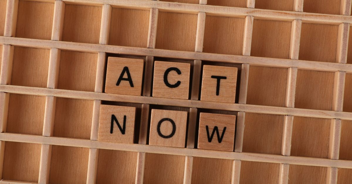 Wooden Scrabble letters spelling 'Act Now' on a grid, inspiring immediate action.