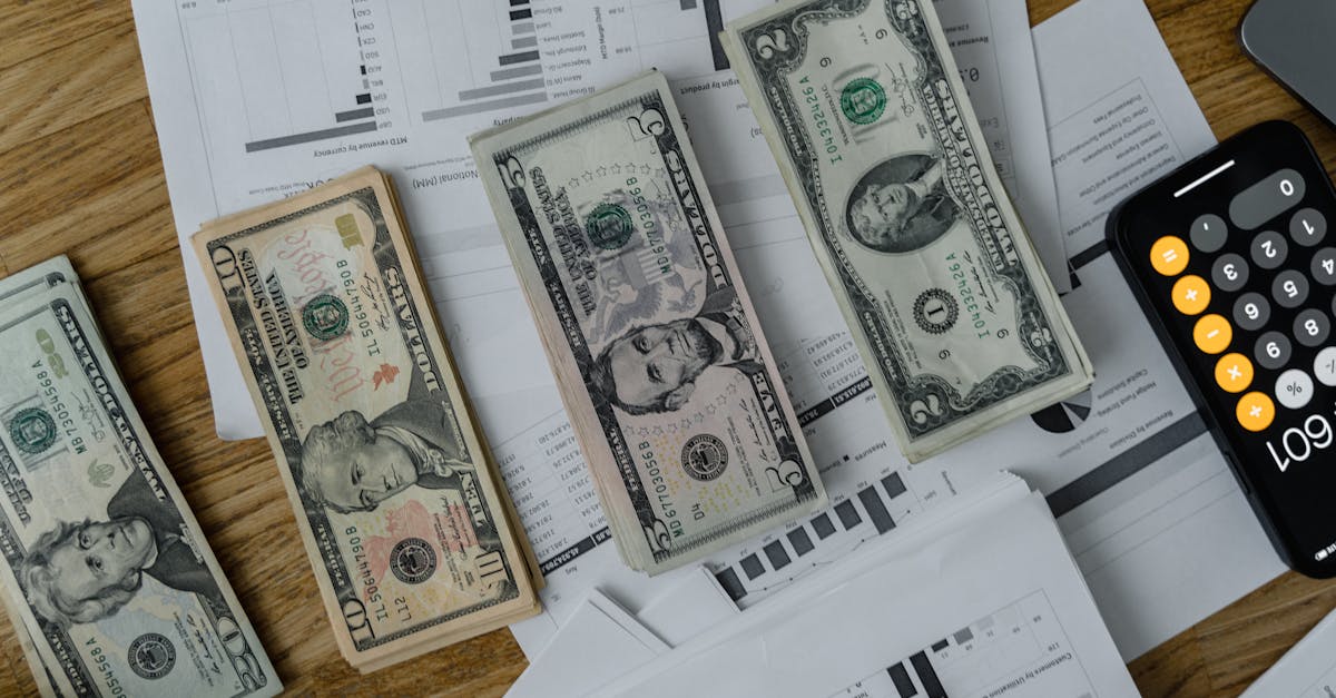 A workspace setup featuring cash, documents, and a calculator symbolizing financial analysis and budgeting.